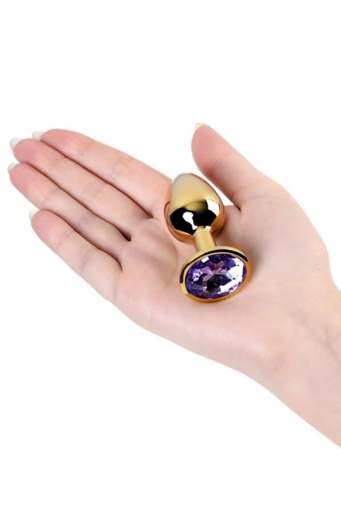 Golden anal plug TOYFA Metal,with a amethyst colored gem Golden anal plug TOYFA Metal,with a amethyst colored gem